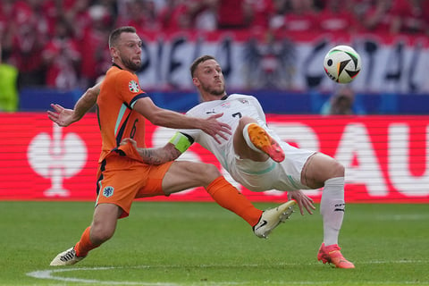 Stefan de Vrij and Marko Arnautovic challenge for the ball